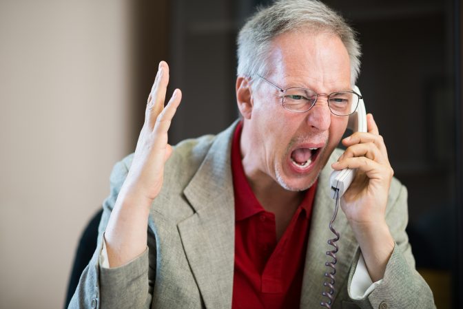 Angry businessman shouting on the phone