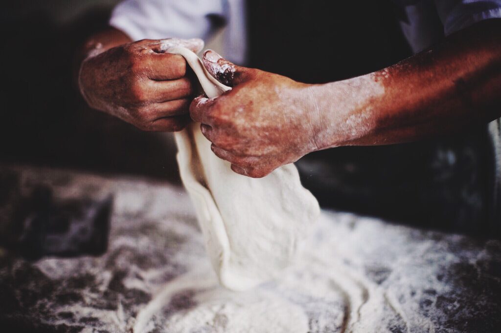 man cooking with flour