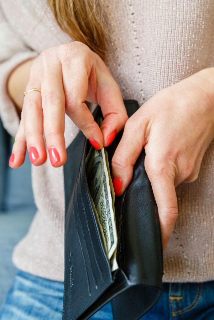 woman taking cash out of wallet