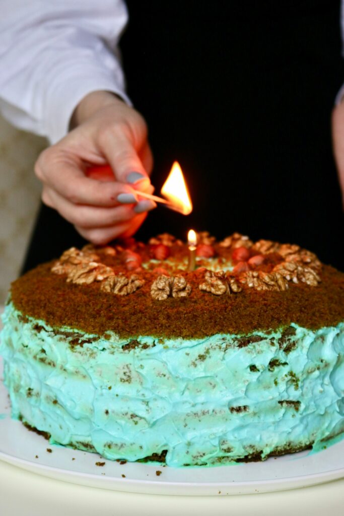 a-young-caucasian-girl-lights-a-candle-on-her-birthday-cake-shes-celebrating-her-birthday-homemade_t20_029AKw