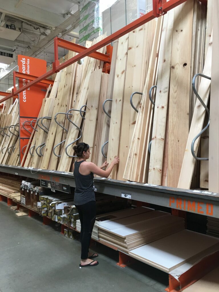 Home depot - woman picking out lumber - How To Use Home Depot Store Credit Without ID