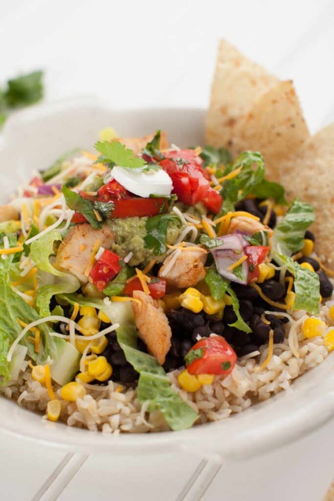 What Cut Of Steak Does Chipotle Use? Featuring bowl with rice, beans, tomatoes, steak